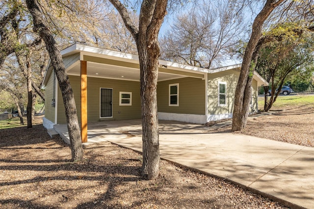 rear view of house featuring a carport