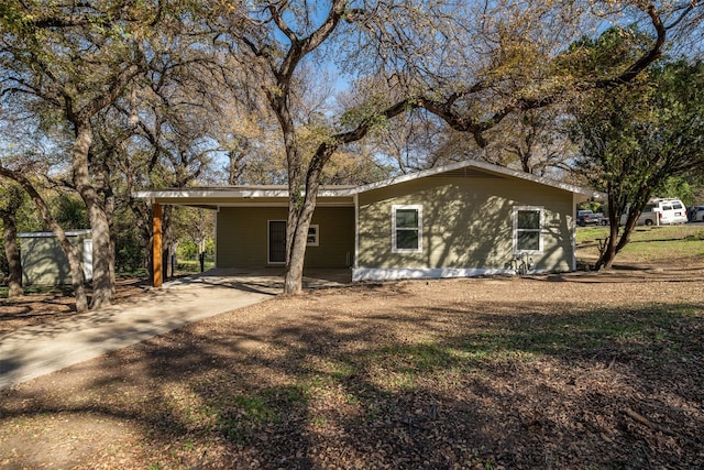 back of property featuring a carport