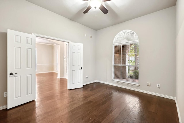 unfurnished room with ceiling fan and dark wood-type flooring