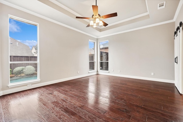 2543 Sir Tristram Ln, Lewisville, TX 75056 - unfurnished room featuring hardwood / wood-style floors, a tray ceiling, ceiling fan, a barn door, and baseboards