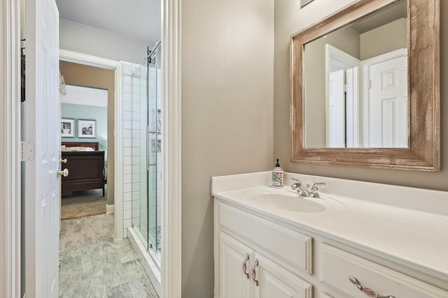 bathroom featuring an enclosed shower and vanity