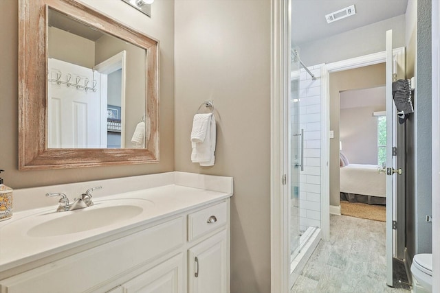 2543 Sir Tristram Ln, Lewisville, TX 75056 - bathroom with a stall shower, vanity, ensuite bathroom, toilet, and wood finished floors
