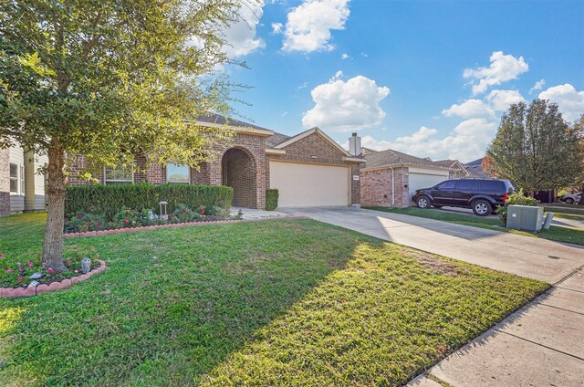 view of front of home with a front yard and a garage