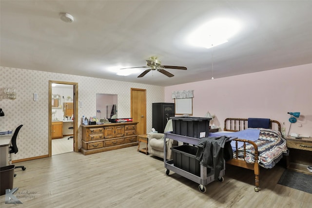 bedroom with ensuite bathroom, ceiling fan, and light wood-type flooring