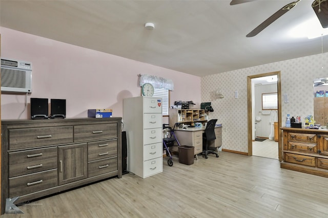 office area with a wall unit AC, ceiling fan, and light hardwood / wood-style floors