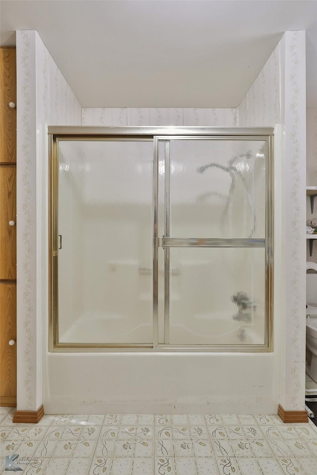 bathroom with shower / bath combination with glass door