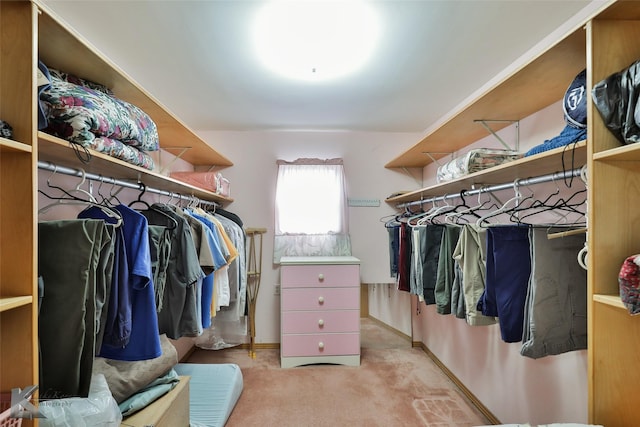 spacious closet featuring light colored carpet