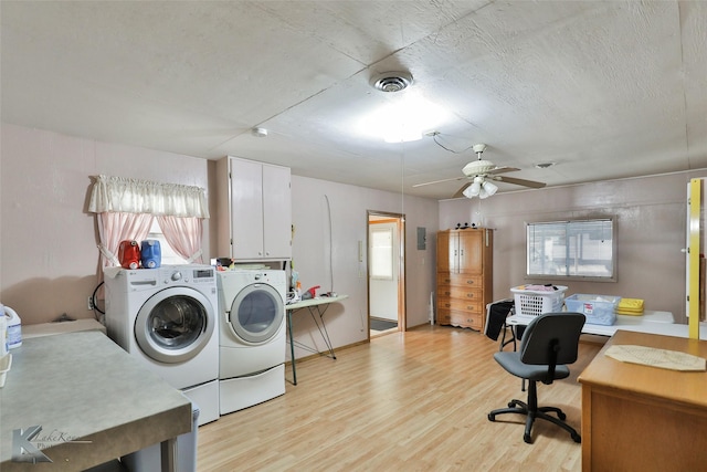 laundry area featuring cabinets, washer and clothes dryer, ceiling fan, and light hardwood / wood-style floors