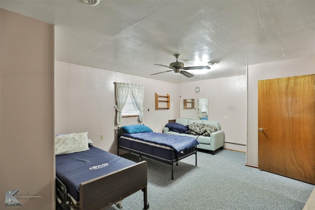 carpeted bedroom with ceiling fan and a baseboard heating unit