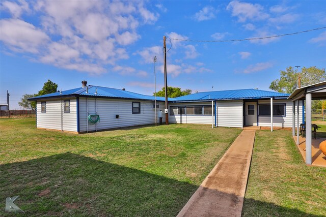 back of property featuring a yard