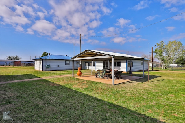 back of house featuring a yard and a patio