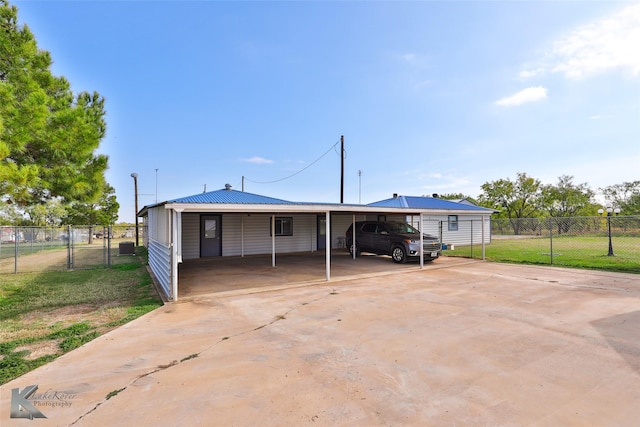 rear view of house with a yard and a carport