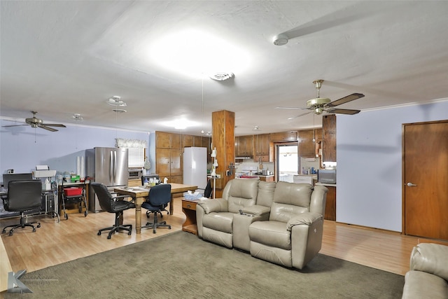 living room with hardwood / wood-style floors and ceiling fan