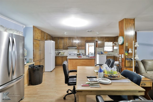 dining area with light hardwood / wood-style flooring and sink