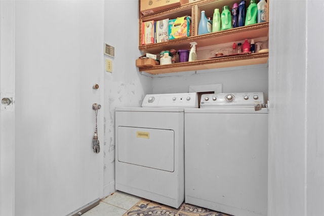 laundry room featuring independent washer and dryer and light tile patterned floors