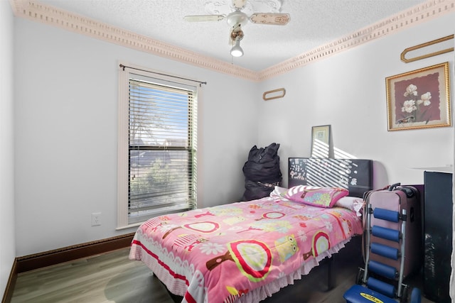 bedroom featuring ceiling fan, wood-type flooring, and a textured ceiling