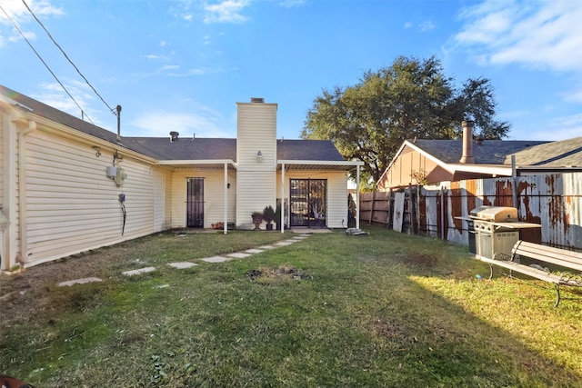 back of property featuring a lawn