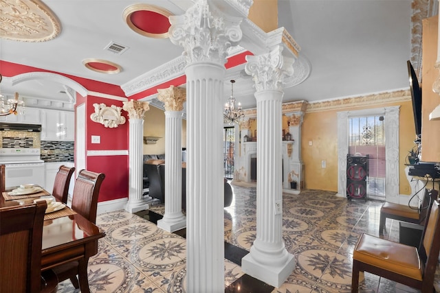 interior space featuring decorative columns and ornamental molding