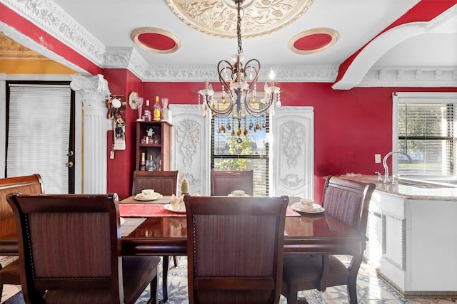 dining area featuring an inviting chandelier, ornamental molding, and sink