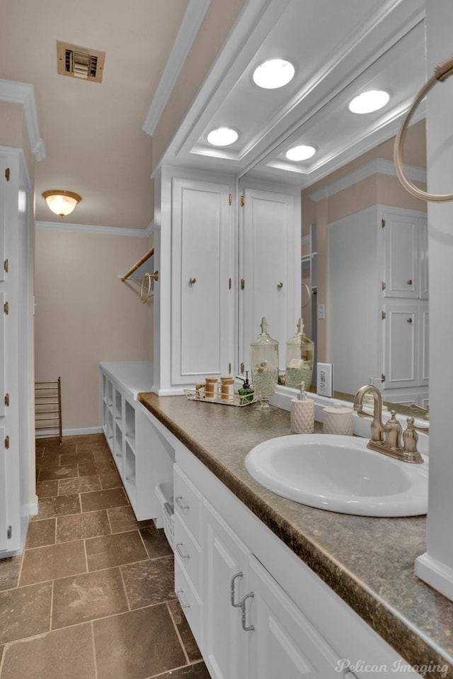 bathroom featuring vanity and ornamental molding