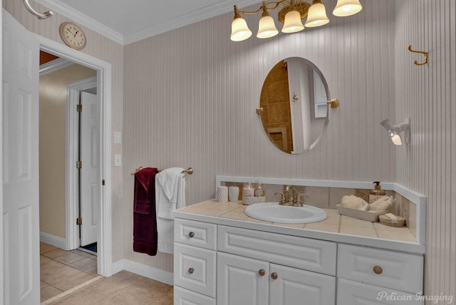 bathroom with ornamental molding, tile patterned floors, and vanity