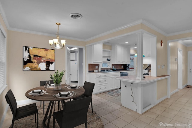 kitchen featuring pendant lighting, sink, crown molding, white cabinets, and kitchen peninsula