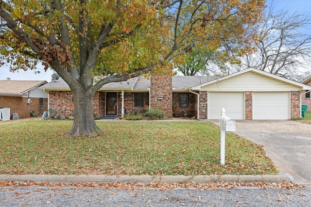 single story home featuring a front lawn and a garage