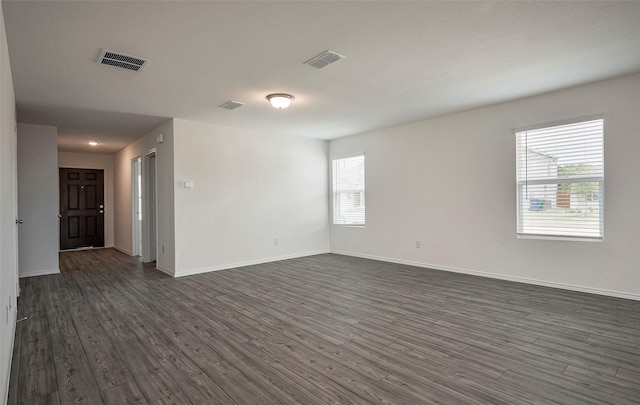 spare room featuring dark hardwood / wood-style flooring