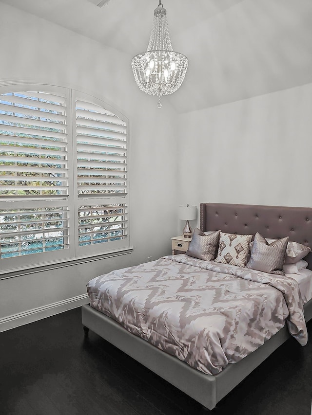 bedroom featuring a chandelier and hardwood / wood-style floors