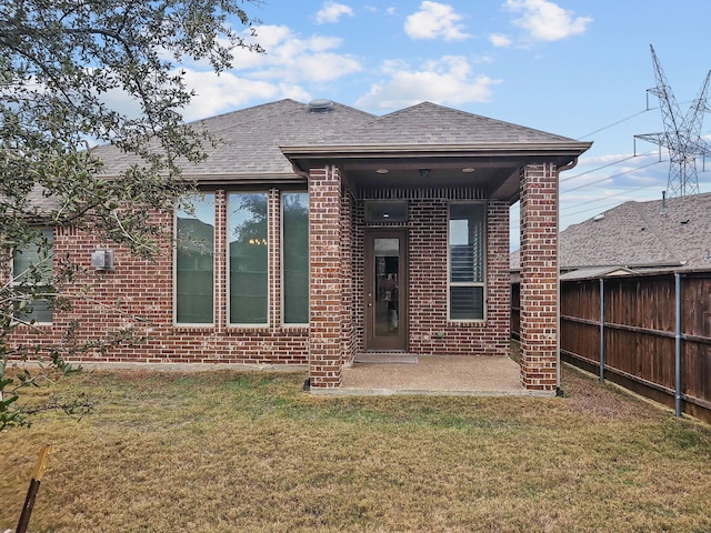 rear view of property featuring a yard and a patio