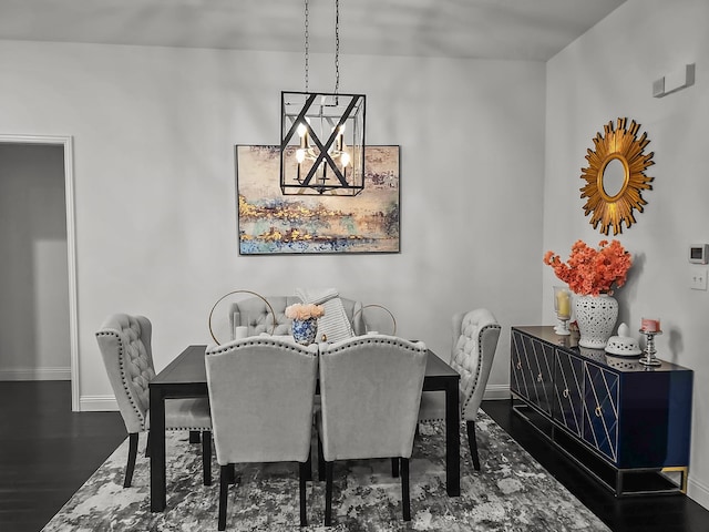 dining room featuring dark hardwood / wood-style flooring and a chandelier