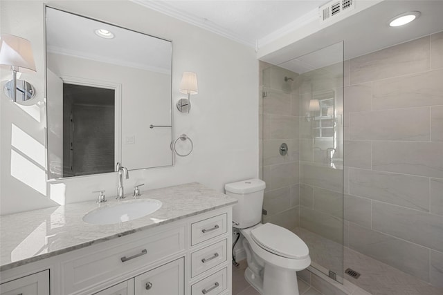 bathroom with tile patterned floors, ornamental molding, vanity, tiled shower, and toilet