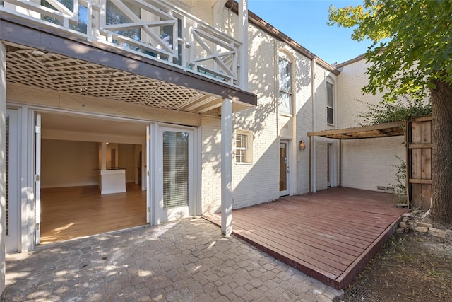 exterior space with a patio, a balcony, and a wooden deck