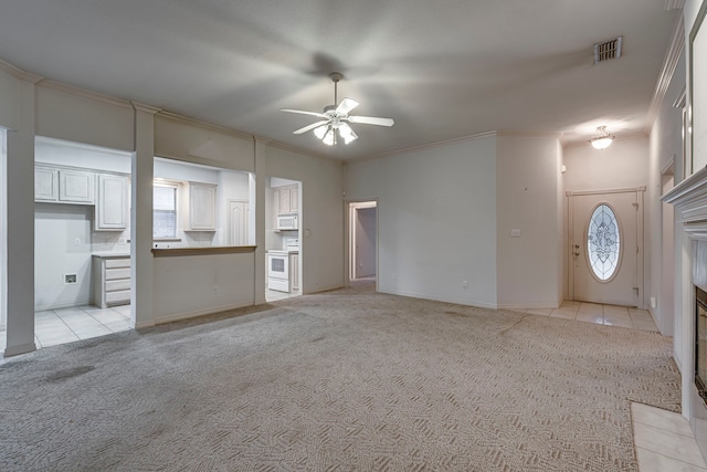 unfurnished living room with light carpet, ceiling fan, and ornamental molding