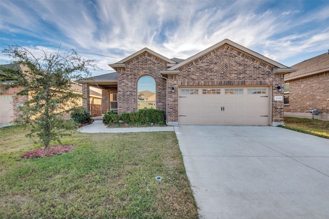 view of front of property with a front lawn and a garage