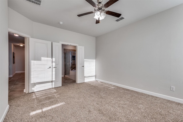 unfurnished bedroom with carpet, connected bathroom, and ceiling fan