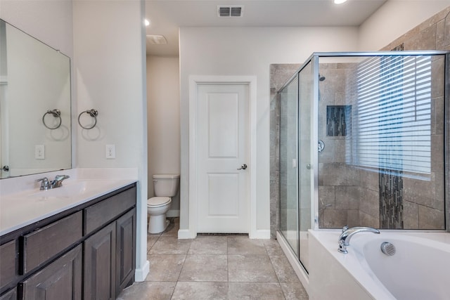 full bathroom featuring tile patterned flooring, vanity, shower with separate bathtub, and toilet