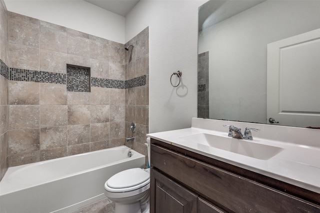 full bathroom with vanity, tiled shower / bath combo, and toilet