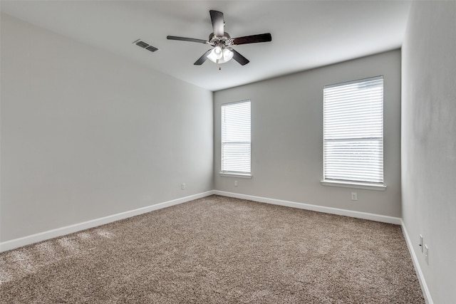 spare room featuring carpet flooring and ceiling fan