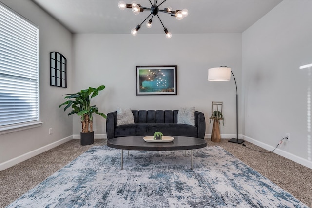 living room featuring a wealth of natural light, carpet floors, and a chandelier