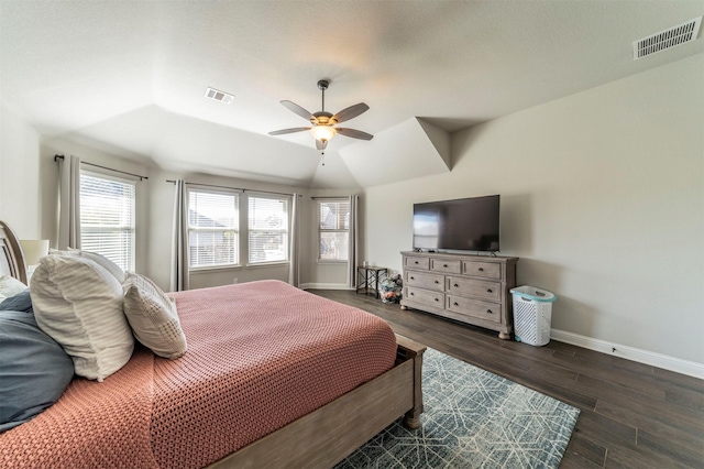 bedroom featuring dark hardwood / wood-style flooring, vaulted ceiling, and ceiling fan