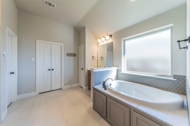 bathroom with vanity and a washtub