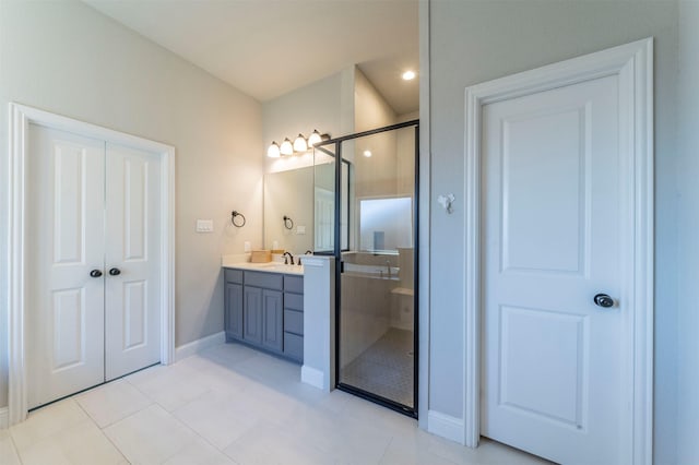 bathroom with tile patterned floors, vanity, and an enclosed shower