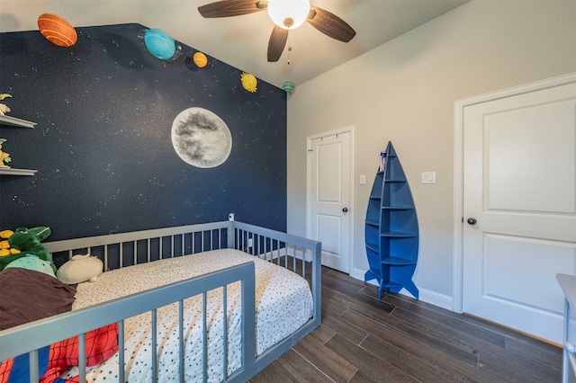 bedroom with ceiling fan, lofted ceiling, and dark hardwood / wood-style floors