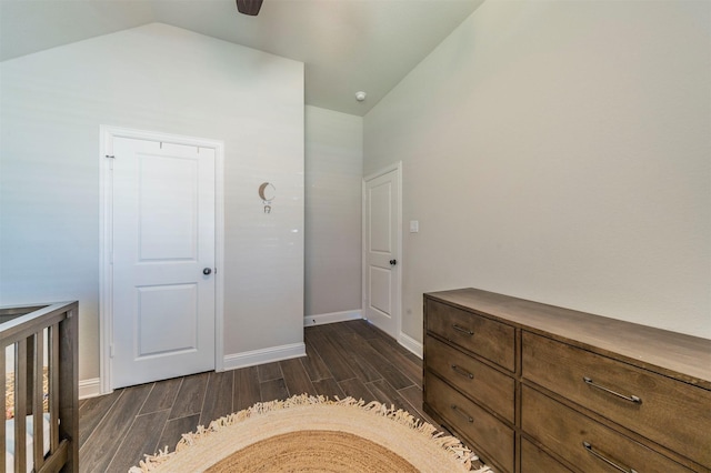 unfurnished bedroom with vaulted ceiling and dark hardwood / wood-style floors