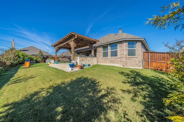 back of property with a yard, a pergola, and a patio