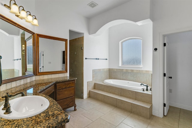 bathroom with a stall shower, visible vents, tile patterned flooring, vanity, and a bath