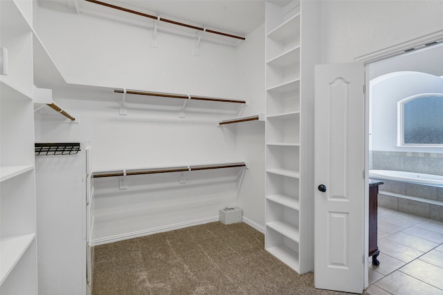 spacious closet with light tile patterned floors