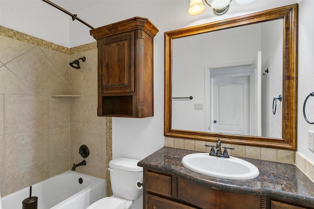 full bathroom with vanity, toilet, and tiled shower / bath