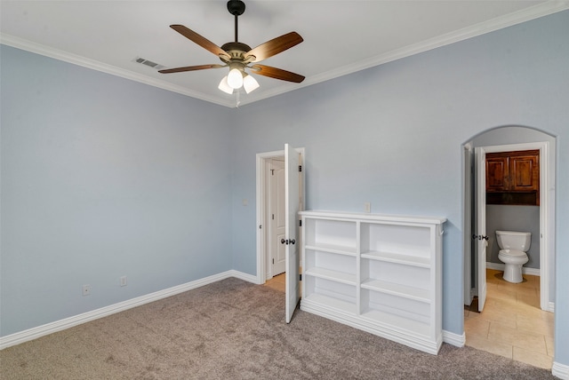 unfurnished bedroom featuring carpet floors, visible vents, crown molding, and baseboards